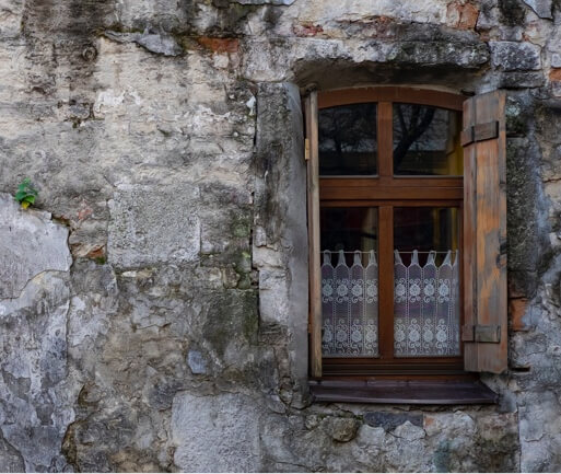 the wooden door of an old concrete building